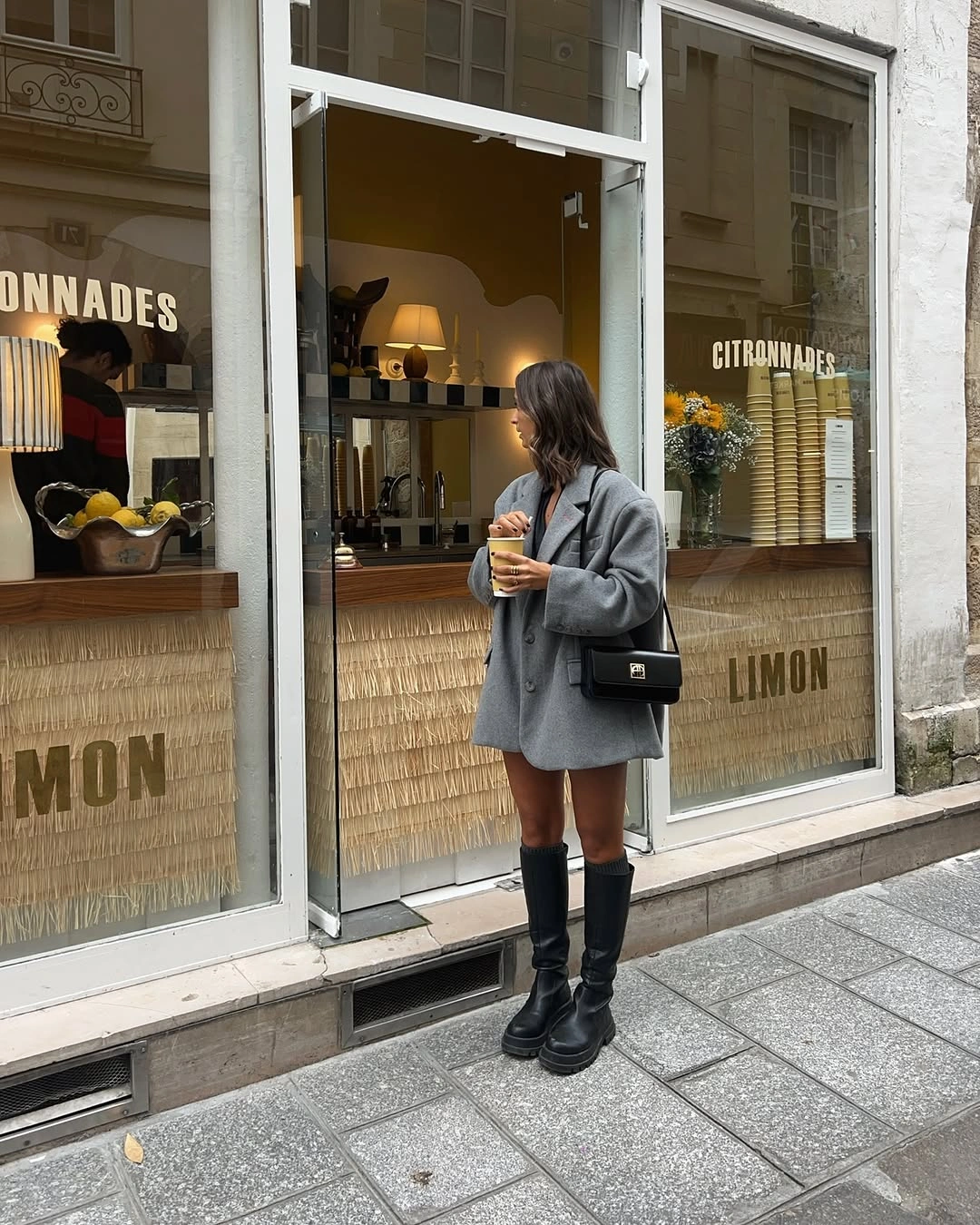 September outfit ideas 2026 oversized gray blazer and knee-high boots for a chic September dress alternative