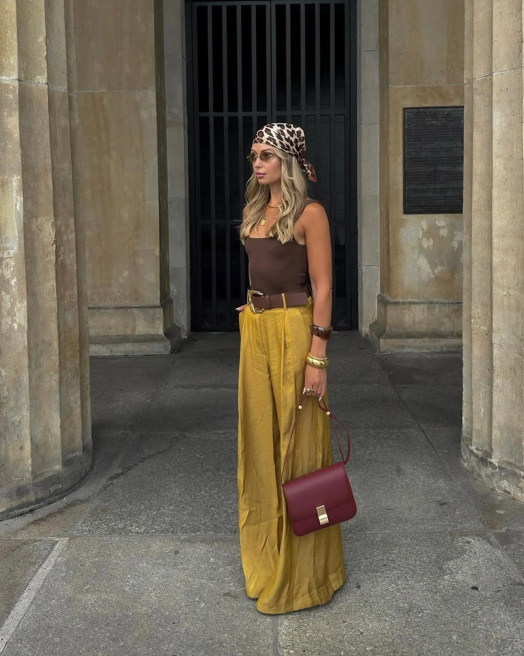 September outfit ideas 2026 Chocolate tank and golden wide-leg trousers with burgundy accents