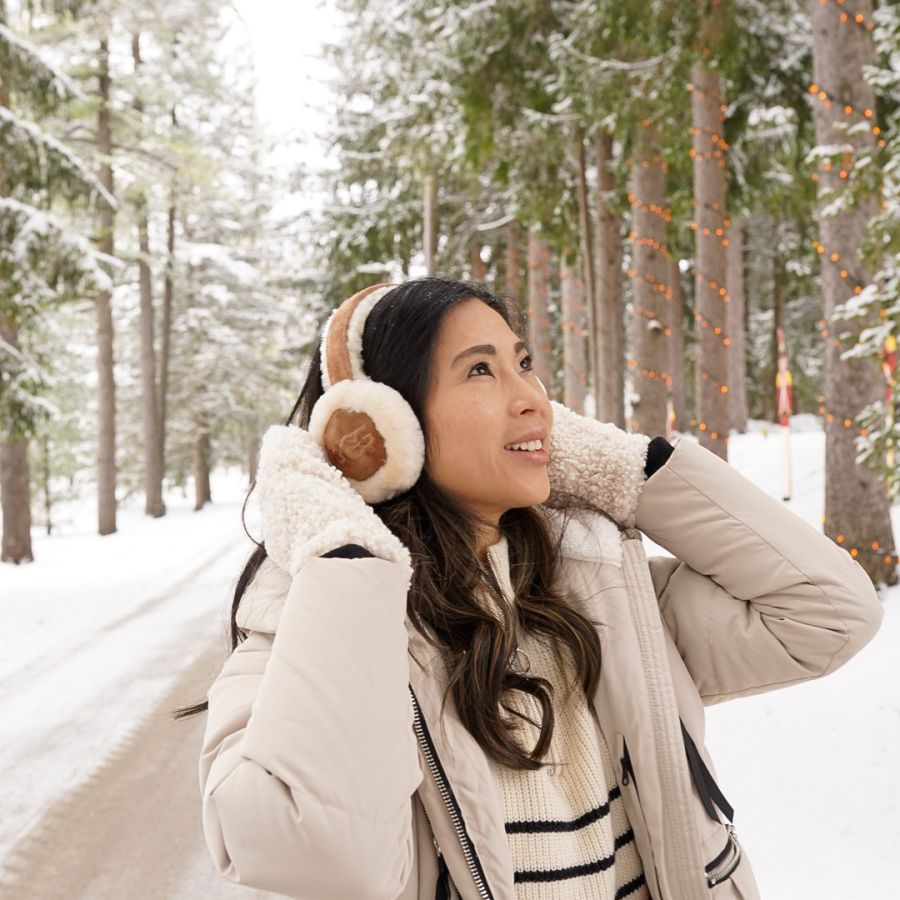 Shearling Earmuffs with a Cream Puffer Jacket and Striped Sweater — Earmuffs Outfits