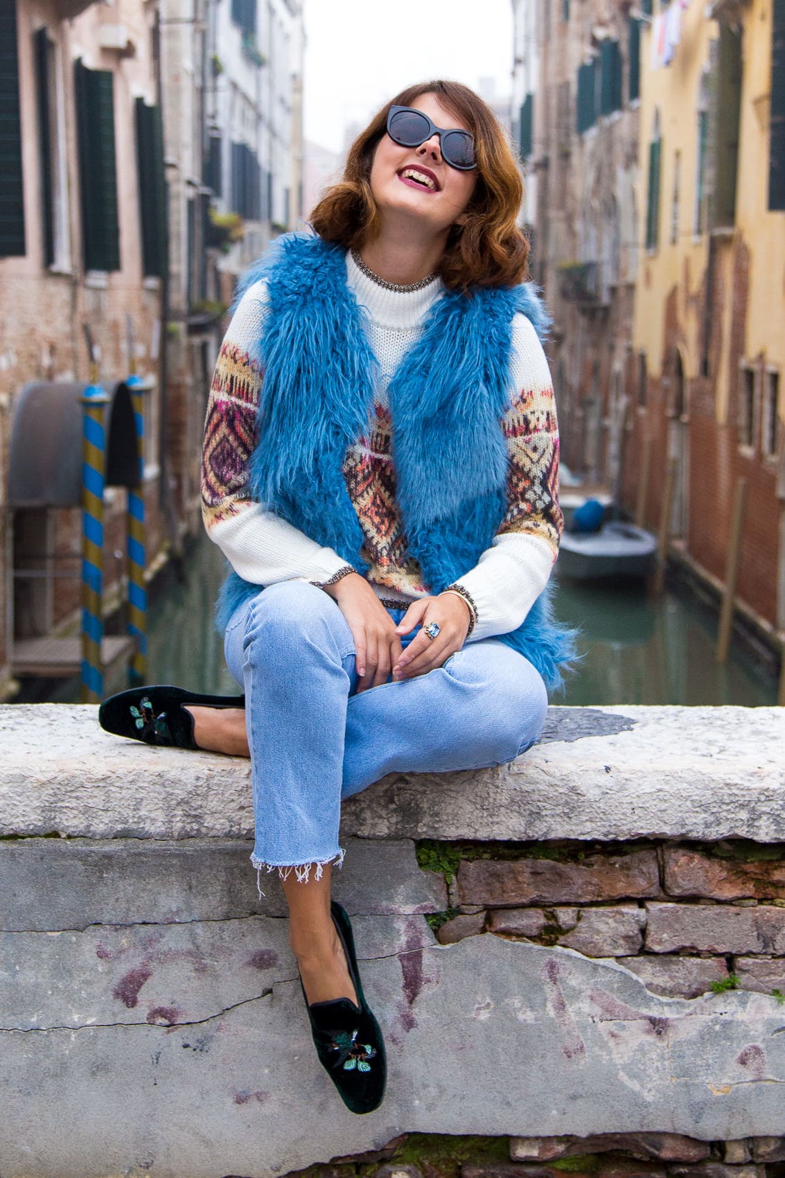 Blue Faux Fur Vest over Patterned Sweater and Jeans Blue Faux Fur Vest over Patterned Sweater and Jeans — Italy Winter Outfits