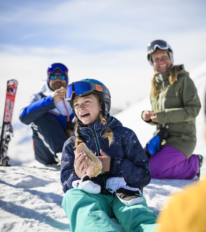 Patterned Ski Jacket and Teal Pants for a Ski Trip Photo — Winter Family Photo Outfits