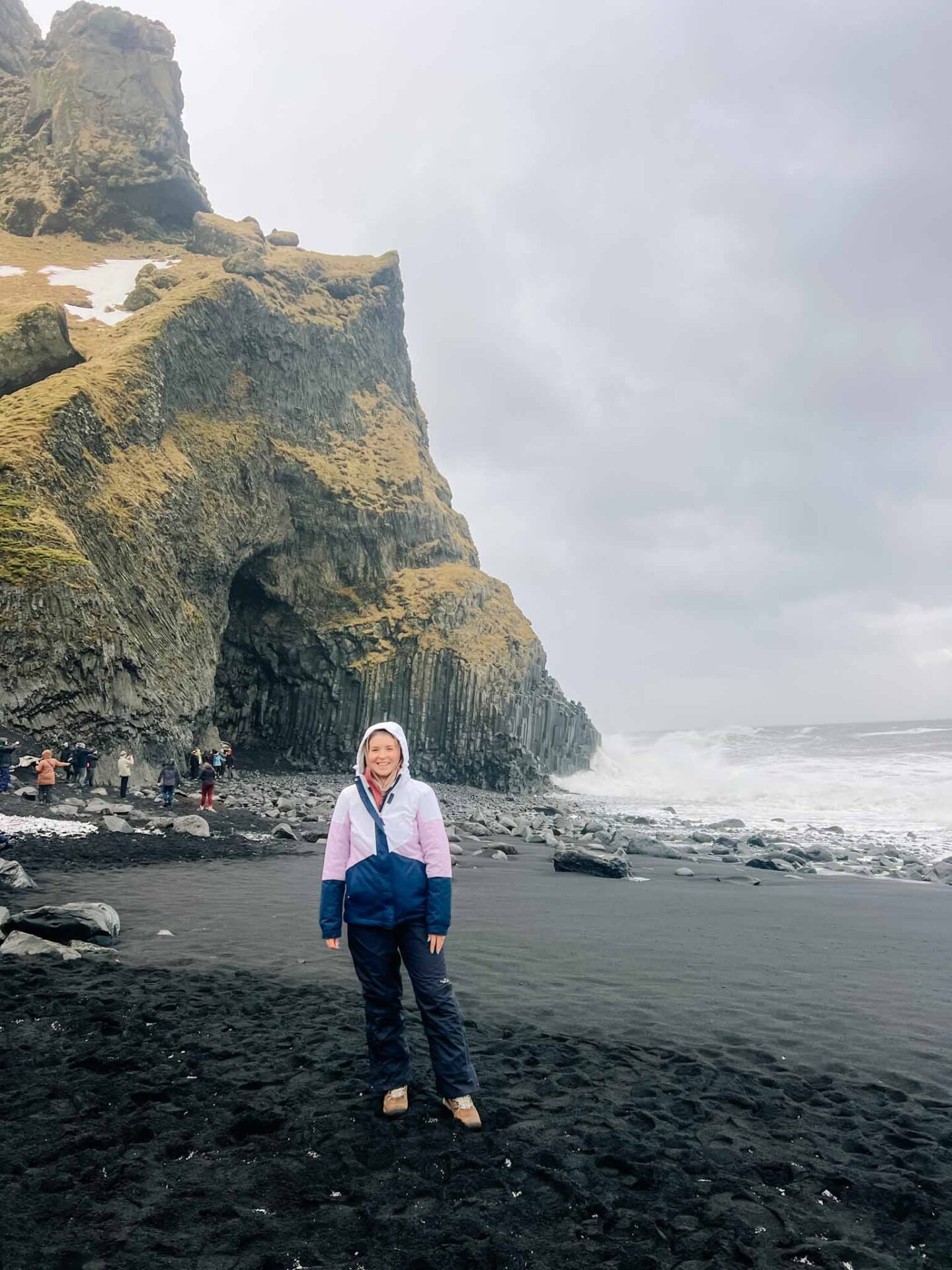 Black Hooded Jacket with Cable-Knit Sweater and Green Beanie Black Hooded Jacket with Cable-Knit Sweater and Green Beanie — Iceland Winter Outfits