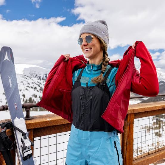 Vibrant Red Jacket Over Black Bib Overlays Vibrant Red Jacket Over Black Bib Overlays — Winter Hiking Outfits