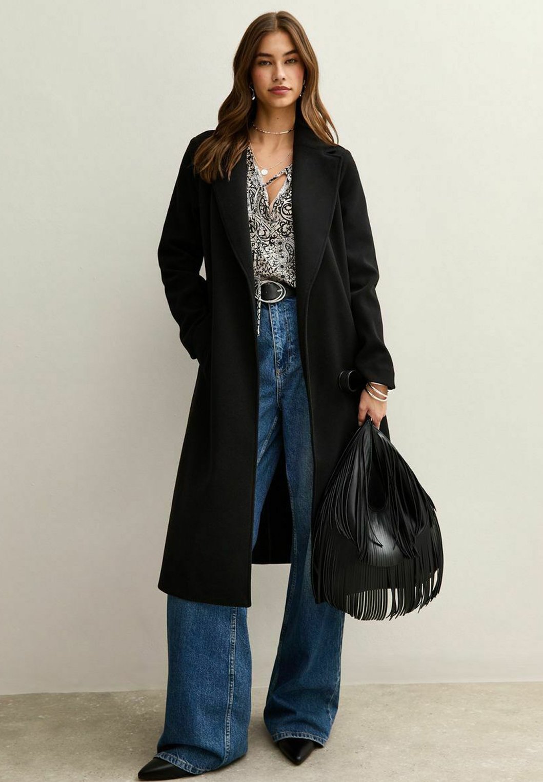 Black Long Coat with Patterned Blouse and Fringed Handbag — Long Coat Outfits