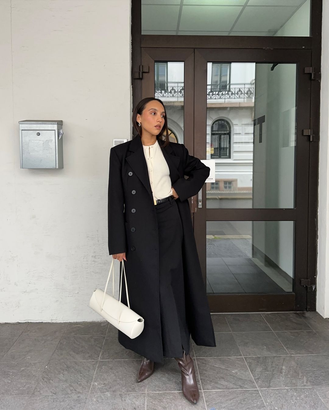 Cream Collared Shirt Under a Longline Black Coat with Brown Boots — Winter Business Casual Outfits