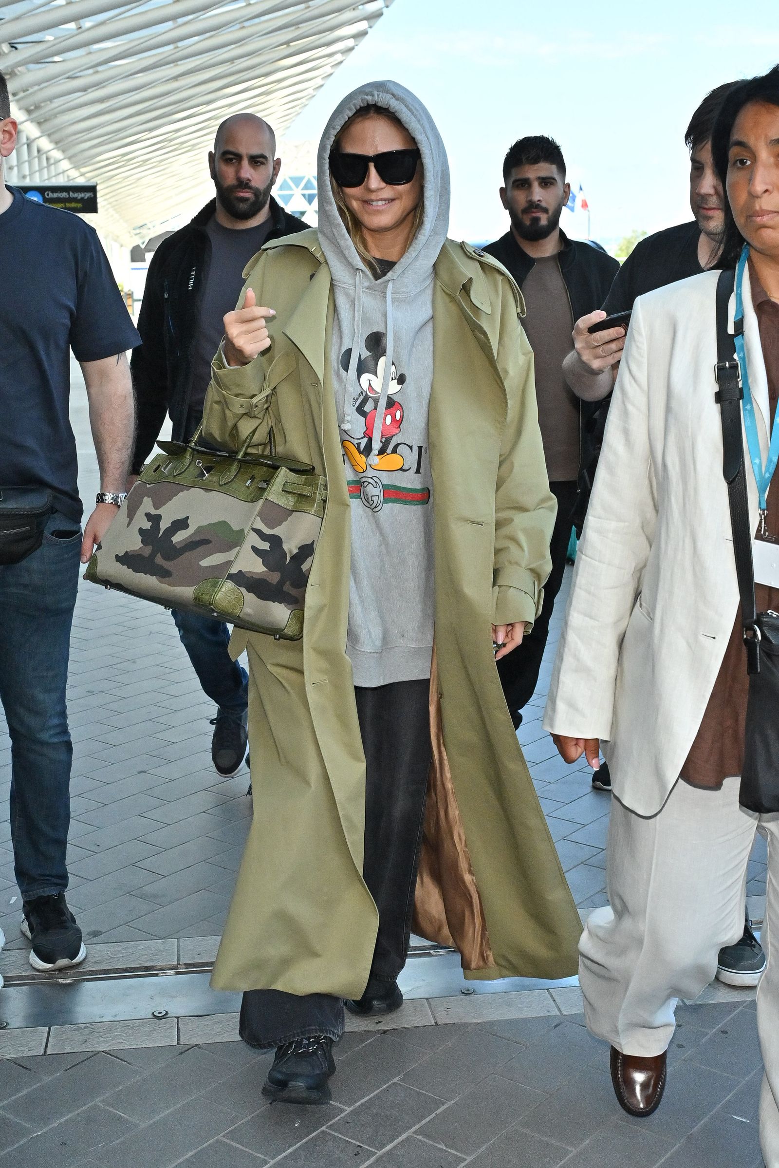 Graphic Hoodie and Trench Coat for a Casual yet Polished Look — Winter Airport Outfits