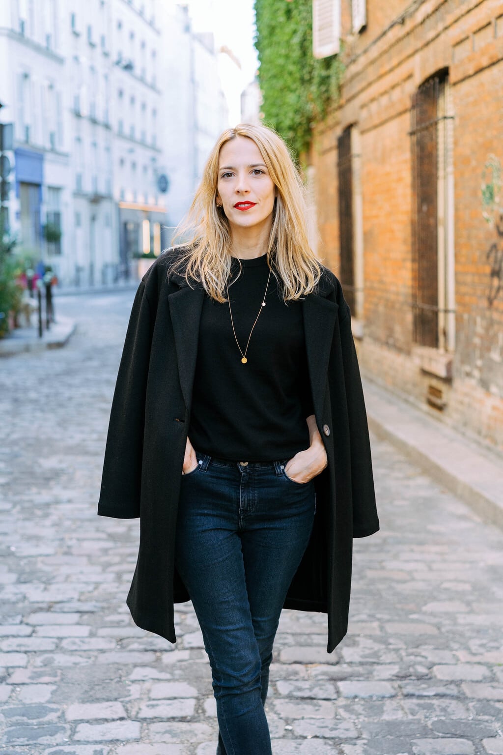 Black Coat Draped Over Shoulders with Denim Jeans — Black Coat Outfits