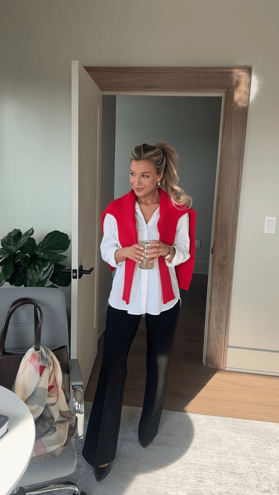 Crisp White Button-Down Shirt Styled with a Red Knit Sweater Draped Over Shoulders — Winter Business Casual Outfits