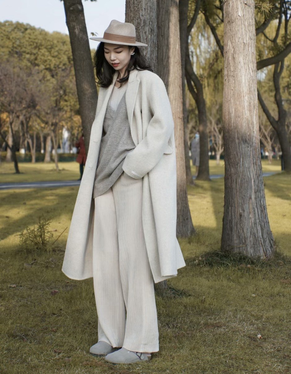 Elegant Cream Wool Coat Over Grey Knitwear — Late Winter Outfits