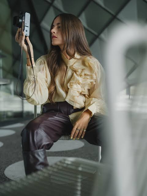 Dark Leather Trousers with a Ruffled Cream Blouse Dark Leather Trousers with a Ruffled Cream Blouse — Leather Pants Outfits