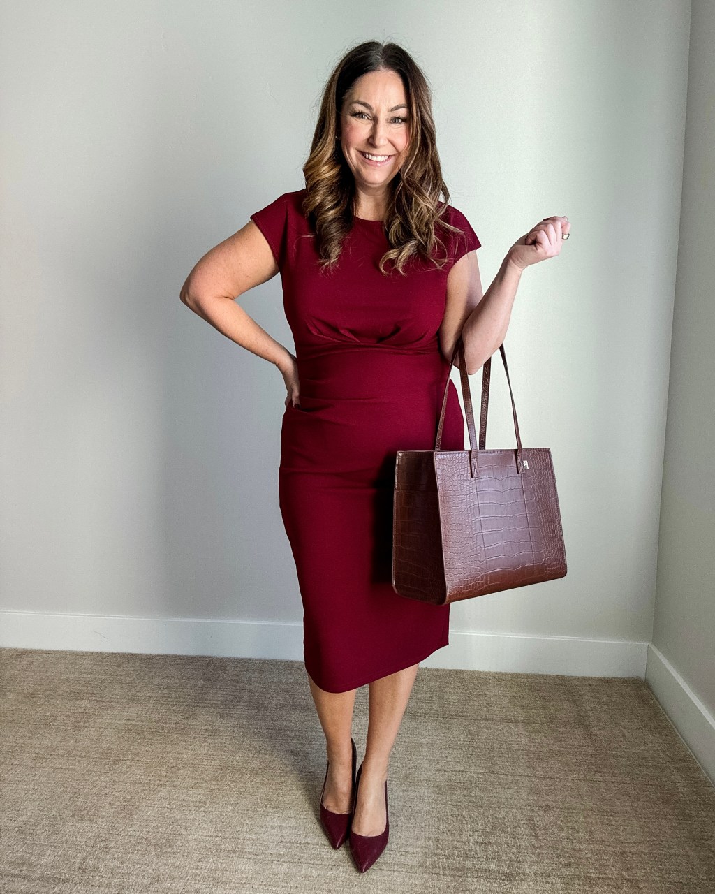 Burgundy Fitted Sheath Dress Styled with Matching Pumps and Tote Bag — Winter Business Casual Outfits
