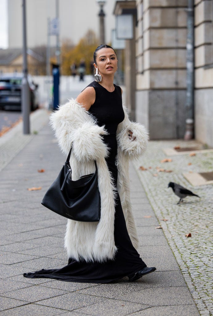 Dramatic Faux Fur Coat Over a Fitted Black Maxi Dress Dramatic Faux Fur Coat Over a Fitted Black Maxi Dress — Winter Party Outfits