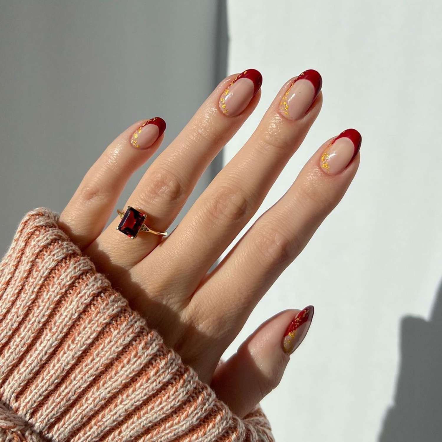 Sheer Nude with Red French Tips and Gold Foil Sheer Nude with Red French Tips and Gold Foil — Short Christmas Nails 2026
