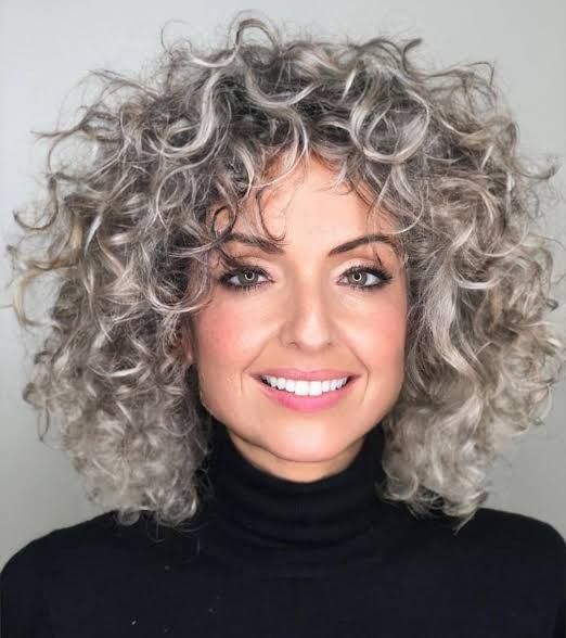 Voluminous Short Curly Cut With Full Bangs Voluminous Short Curly Cut With Full Bangs — Winter Haircuts for Gray Hair
