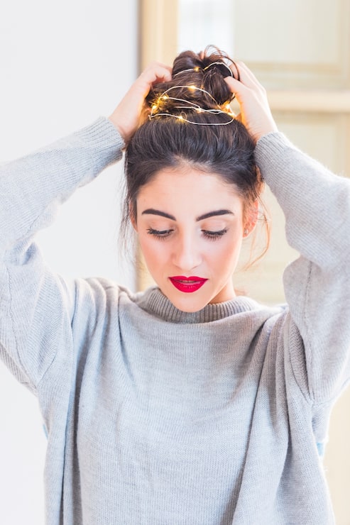 Messy Bun With Decorative Lights Messy Bun With Decorative Lights — Winter Natural Hairstyles