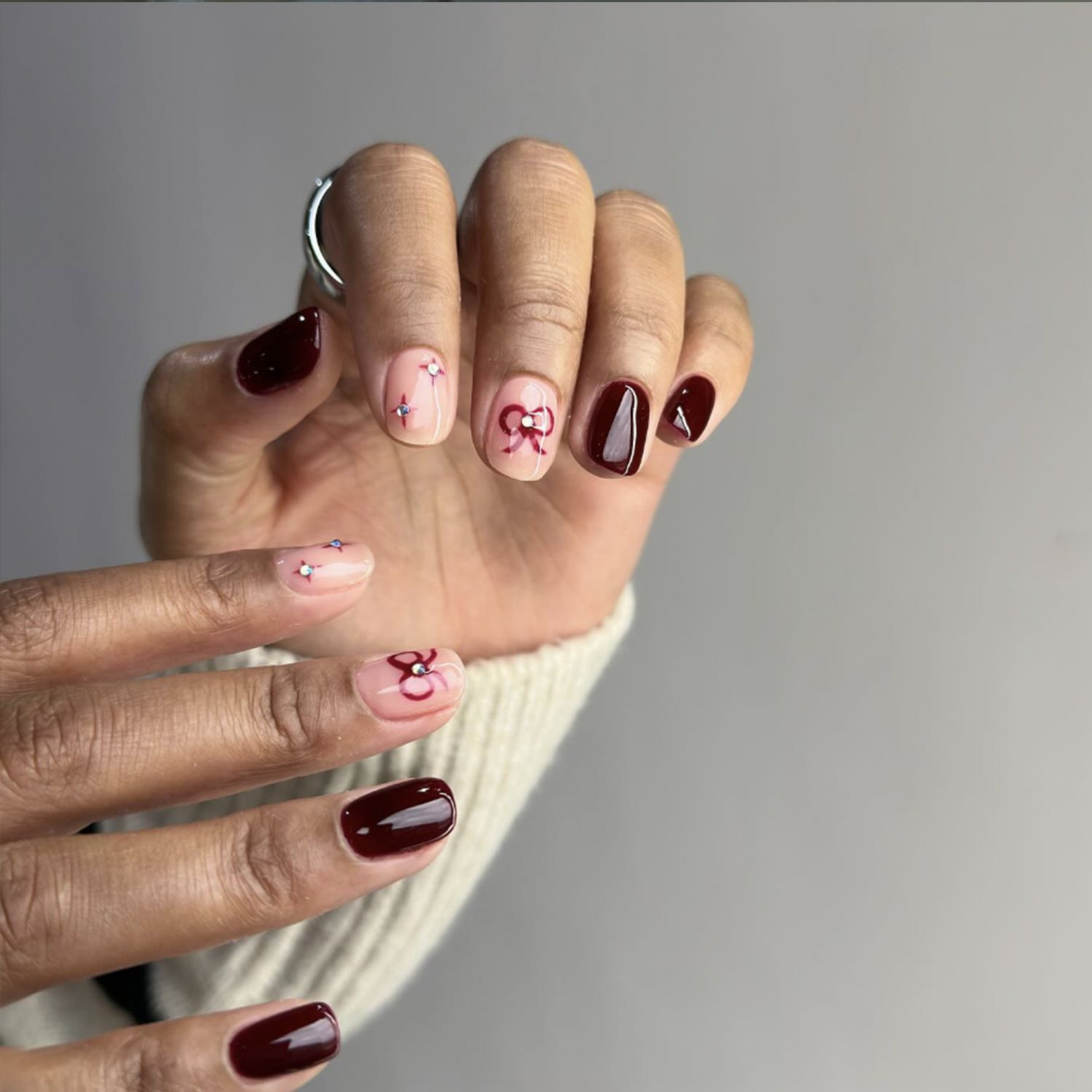 Burgundy and Pink with Rhinestone Bows Burgundy and Pink with Rhinestone Bows — Christmas Nail Art 2026