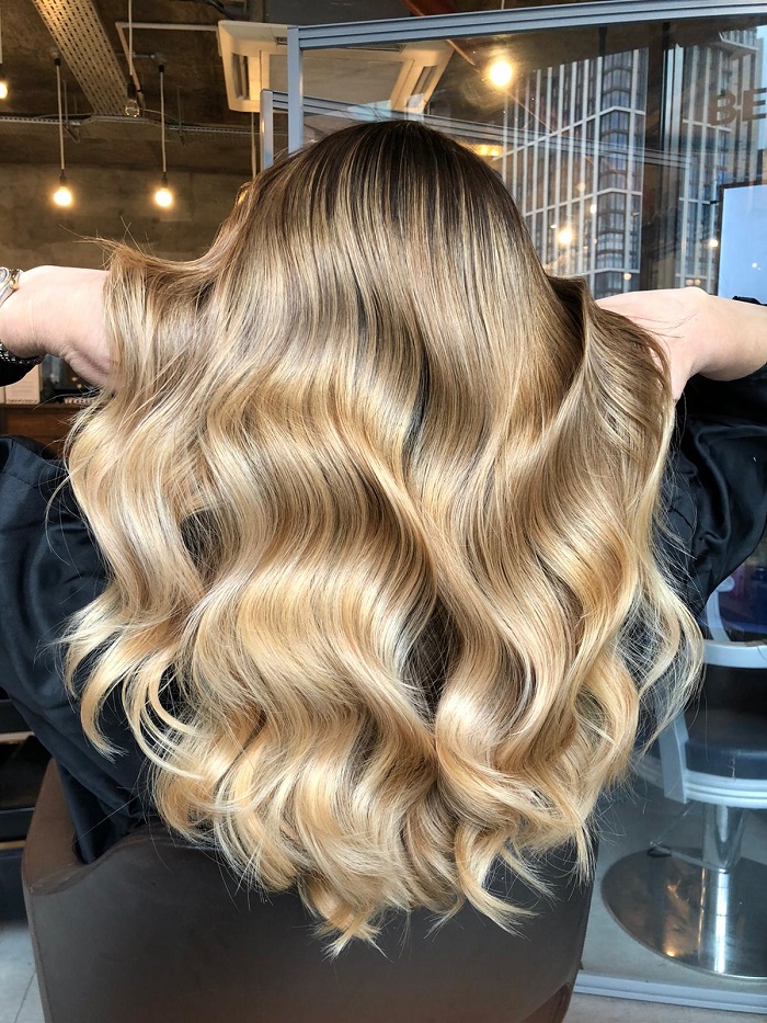 Wavy Blowout With Blonde Highlights — Winter Hairstyles for Work
