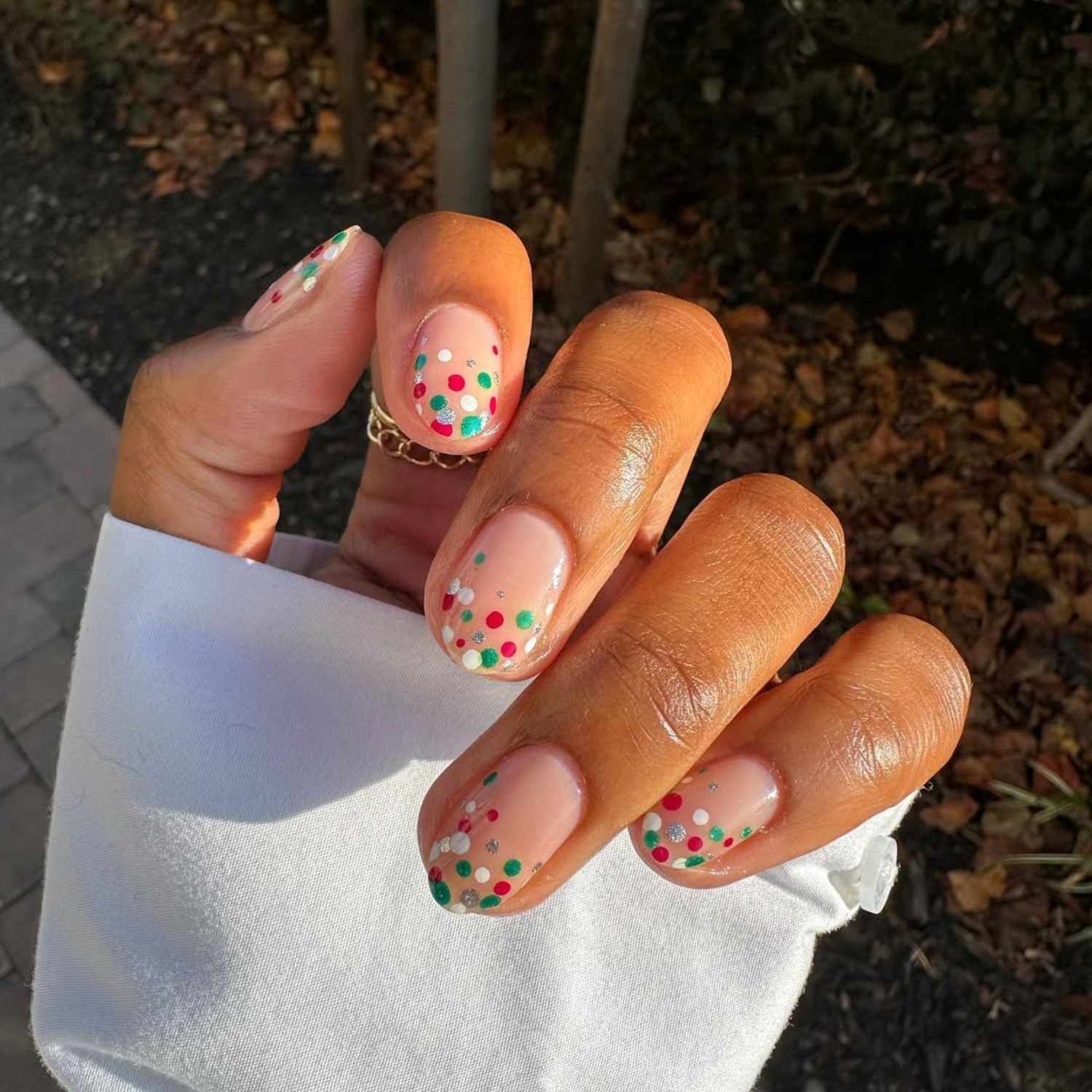 Sheer Pink with Scattered Festive Glitter Dots Sheer Pink with Scattered Festive Glitter Dots — Short Christmas Nails 2026