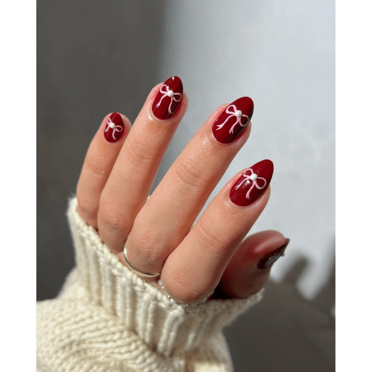 Medium Red Almonds with White Bows Medium Red Almonds with White Bows — Burgundy Christmas Nails 2026