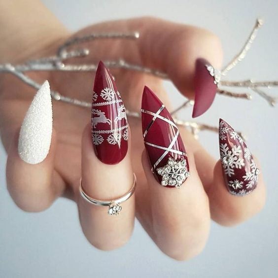 Burgundy Stilettos with Winter Motifs Burgundy Stilettos with Winter Motifs — Christmas Stiletto Nails 2026