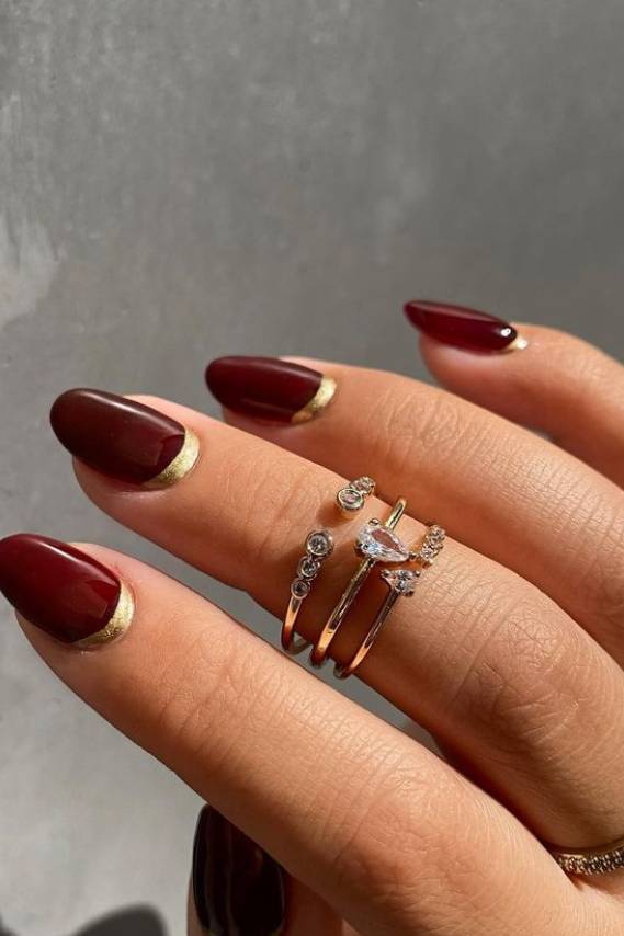 Burgundy Ovals with Metallic Gold French Tips Burgundy Ovals with Metallic Gold French Tips — Burgundy Christmas Nails 2026