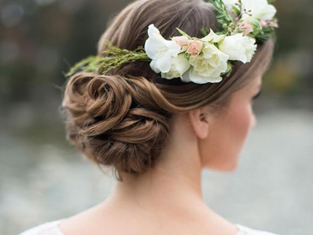 Textured Brown Bun with Floral Accent — Winter Wedding Hairstyles