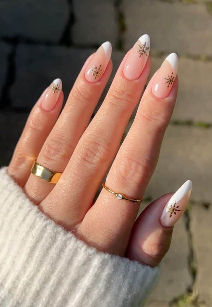 Medium Almond French Tips with Gold Snowflakes Medium Almond French Tips with Gold Snowflakes — Winter Gold Nails