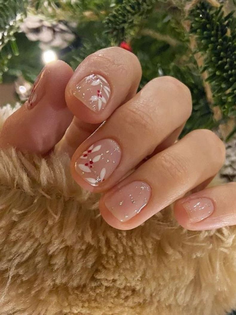 Sheer Nude with White Floral Christmas Accents Sheer Nude with White Floral Christmas Accents — Short Christmas Nails 2026