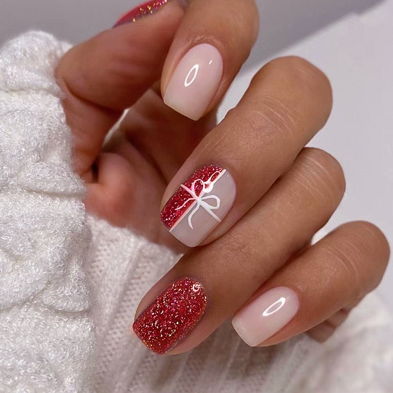 Short Oval Beige Nails With Red Glitter Bow Short Oval Beige Nails With Red Glitter Bow — New Years Press On Nails 2027