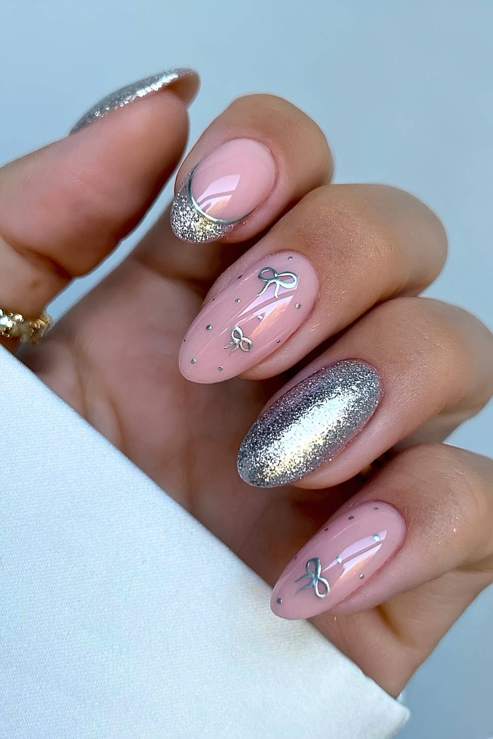 Subtle Silver Glitter Lunula Bow Oval Nails Subtle Silver Glitter Lunula Bow Oval Nails — Christmas Nail Trends 2026