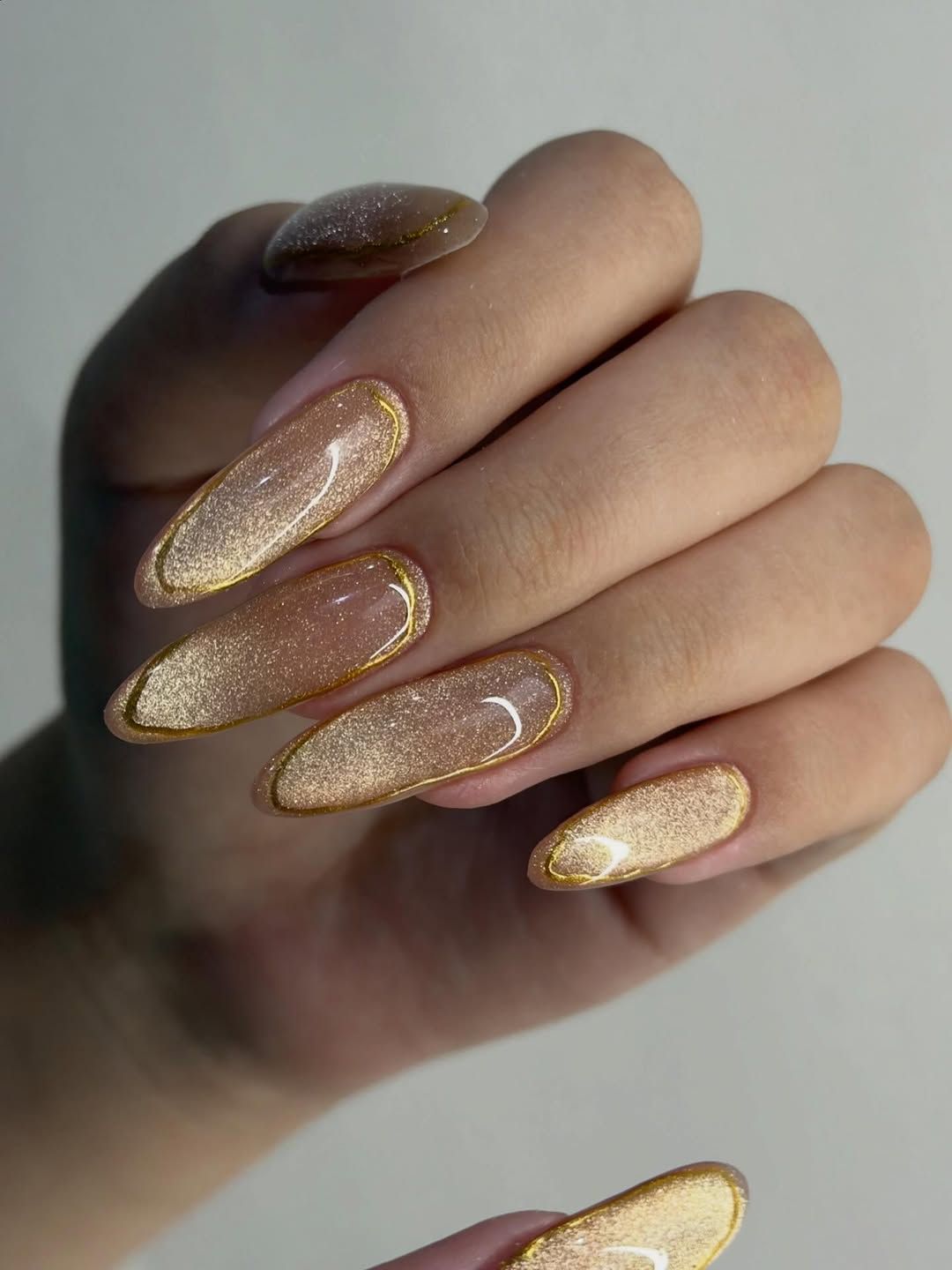 Nude Base with Rose Gold Glitter French and Gold Lines Nude Base with Rose Gold Glitter French and Gold Lines — New Years Nails 2027