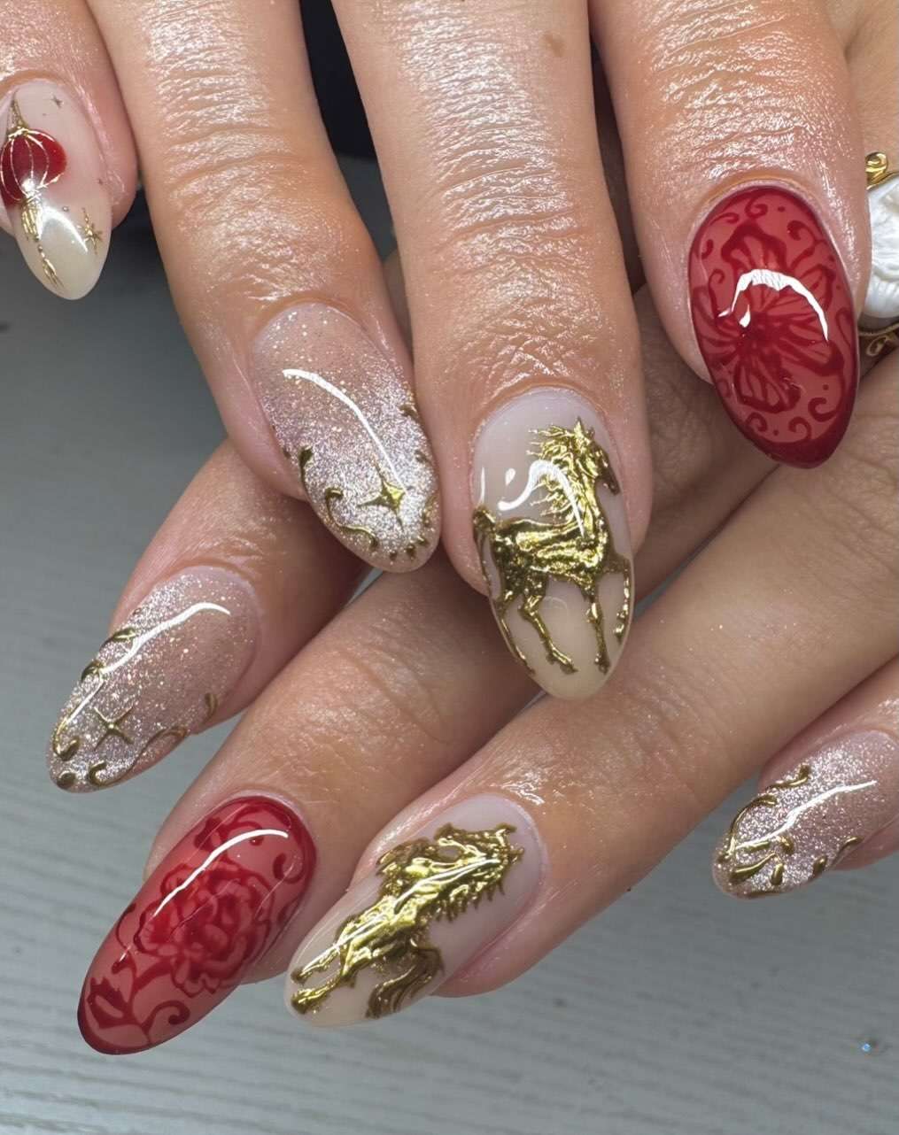 Glossy With Glitter Accents Nude Gold Horse Motifs Nails Glossy With Glitter Accents Nude Gold Horse Motifs Nails — New Years Nail Colors 2027