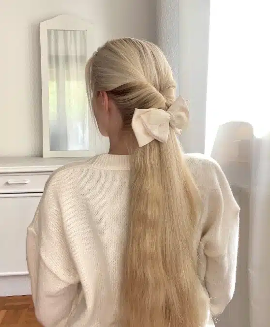 Low Ponytail With Cream Bow — Winter Hairstyles for Work