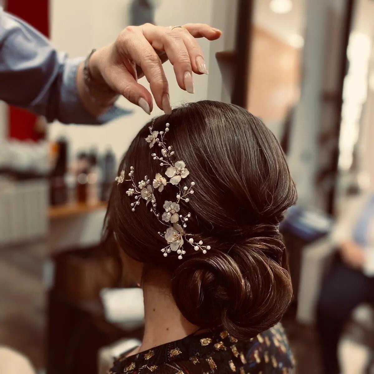 Mid-Back Dark Brown Low Bun With Accessory Mid-Back Dark Brown Low Bun With Accessory — Winter Formal Hairstyles