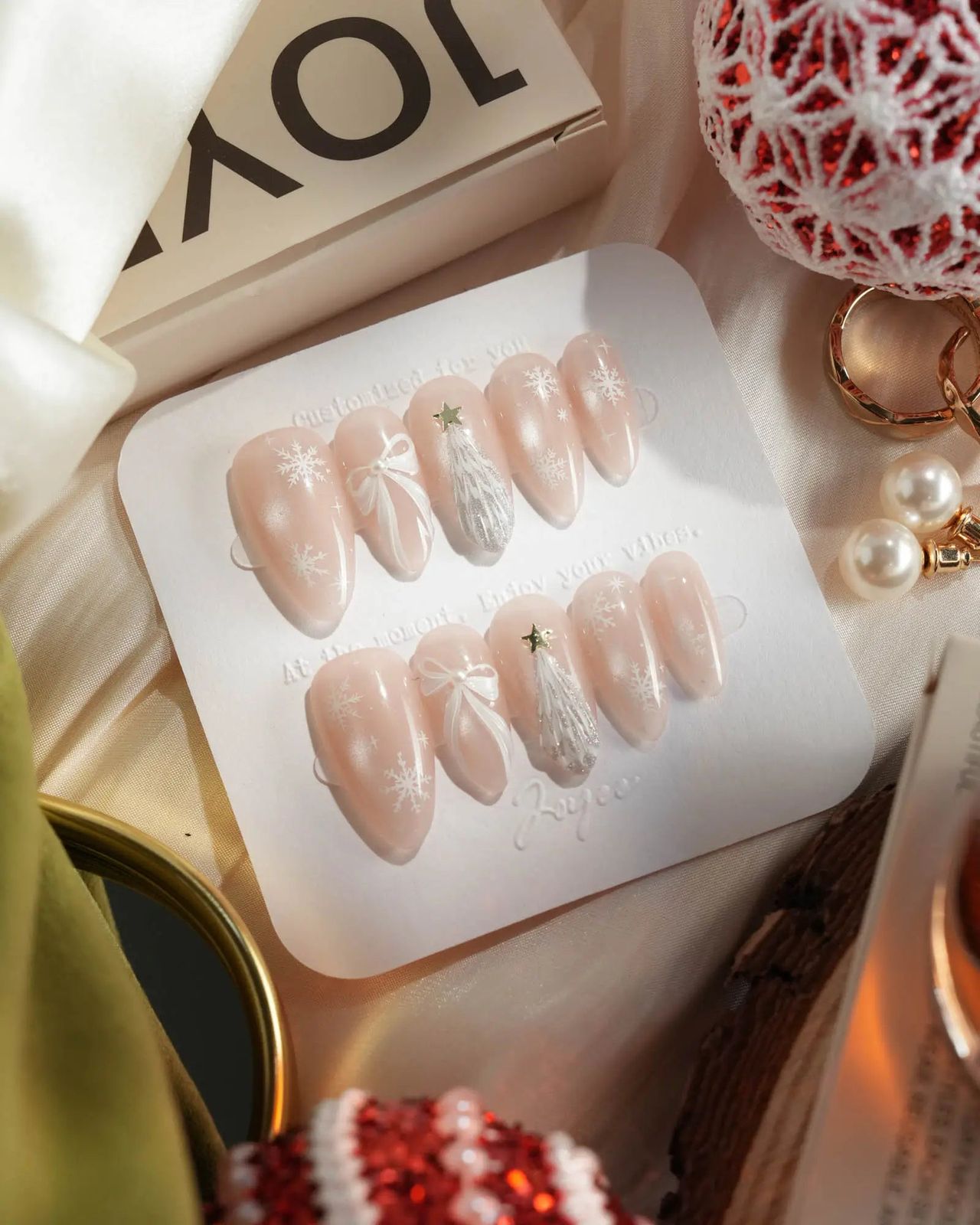 Pale Pink with Snowflakes, Bows, and Stars Pale Pink with Snowflakes, Bows, and Stars — Christmas Oval Nails 2026