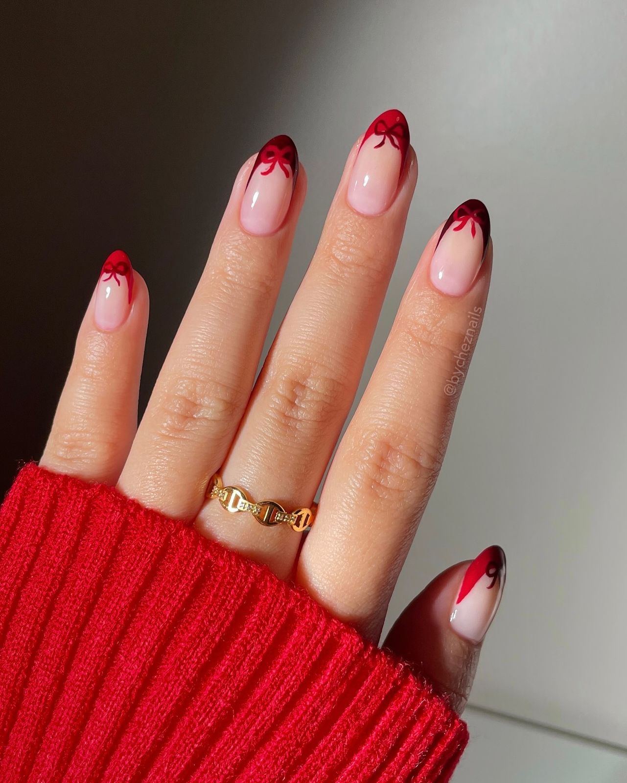 Nude Base with Red Bow French Tips Nude Base with Red Bow French Tips — Christmas Oval Nails 2026