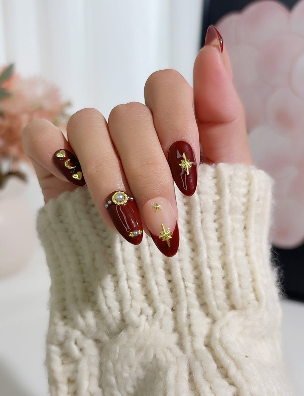 Burgundy Almonds with Celestial Decals and Pearls Burgundy Almonds with Celestial Decals and Pearls — Burgundy Christmas Nails 2026