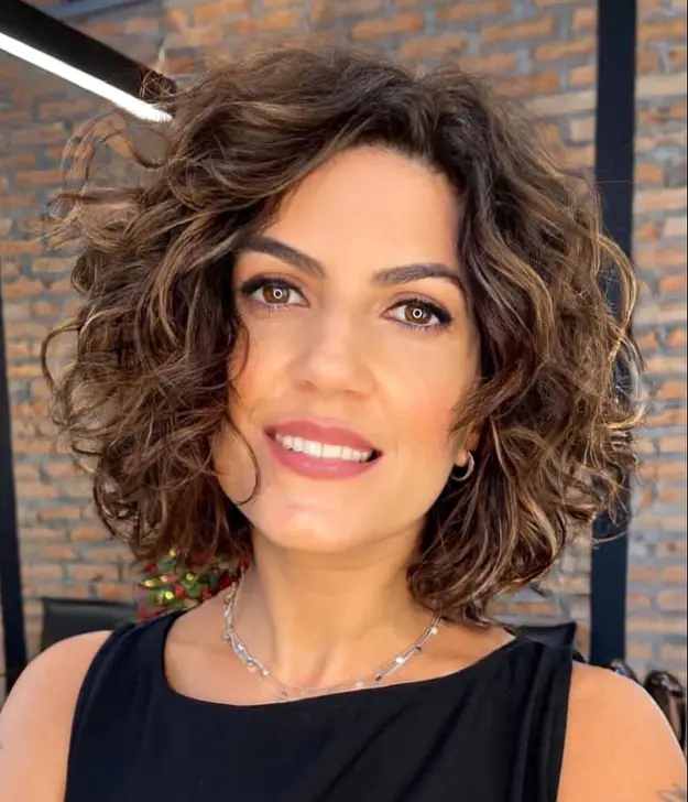 Medium Brown Lob With Voluminous Curls and Caramel Medium Brown Lob With Voluminous Curls and Caramel — Winter Hair Colors for Women Over 40