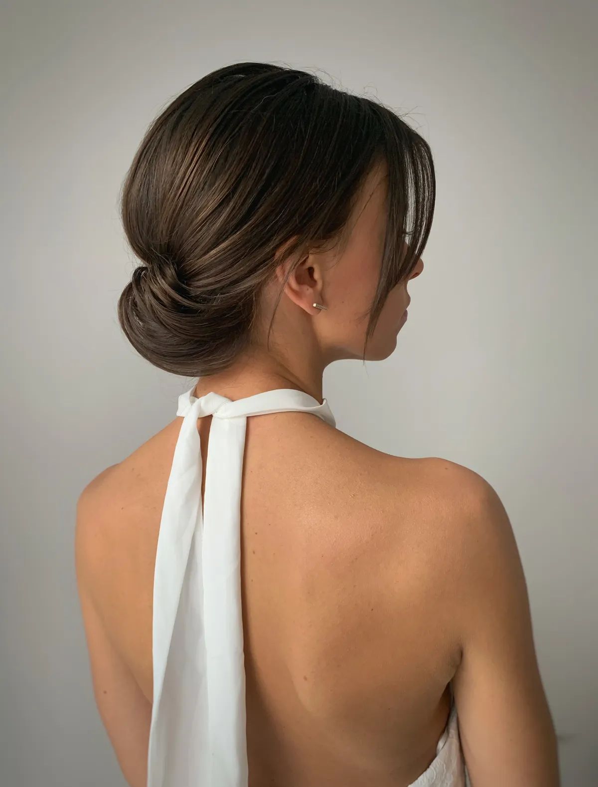 Collarbone Sleek Dark Brown Low Bun With Face-Framing — Winter Bun Hairstyles