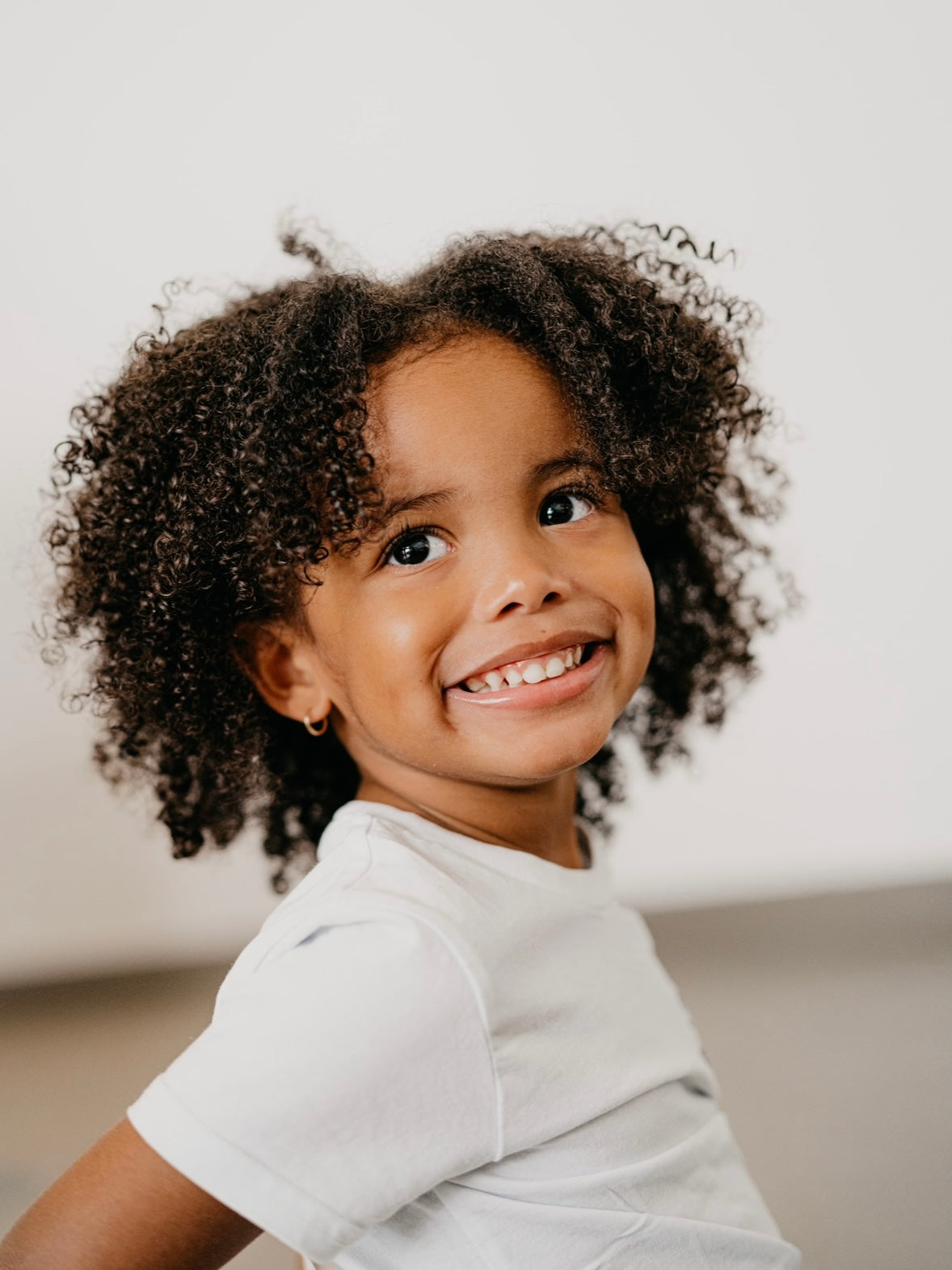 Voluminous Curly Dark Hair Voluminous Curly Dark Hair — Winter Hairstyles for Kids