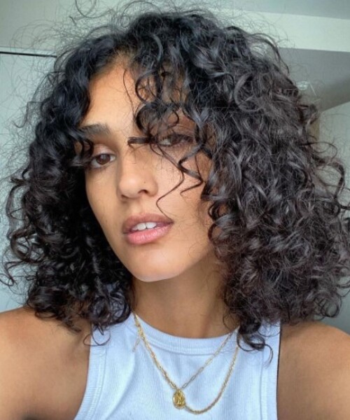Shoulder-Length Dark Bob With Curtain Bangs Shoulder-Length Dark Bob With Curtain Bangs — Winter Haircuts for Curly Hair