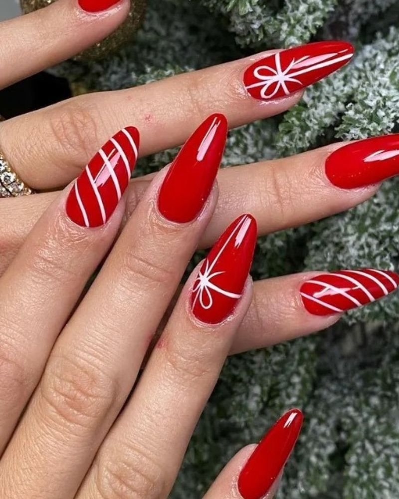 Bright Red Stilettos with White Ribbon Art Bright Red Stilettos with White Ribbon Art — Christmas Stiletto Nails 2026