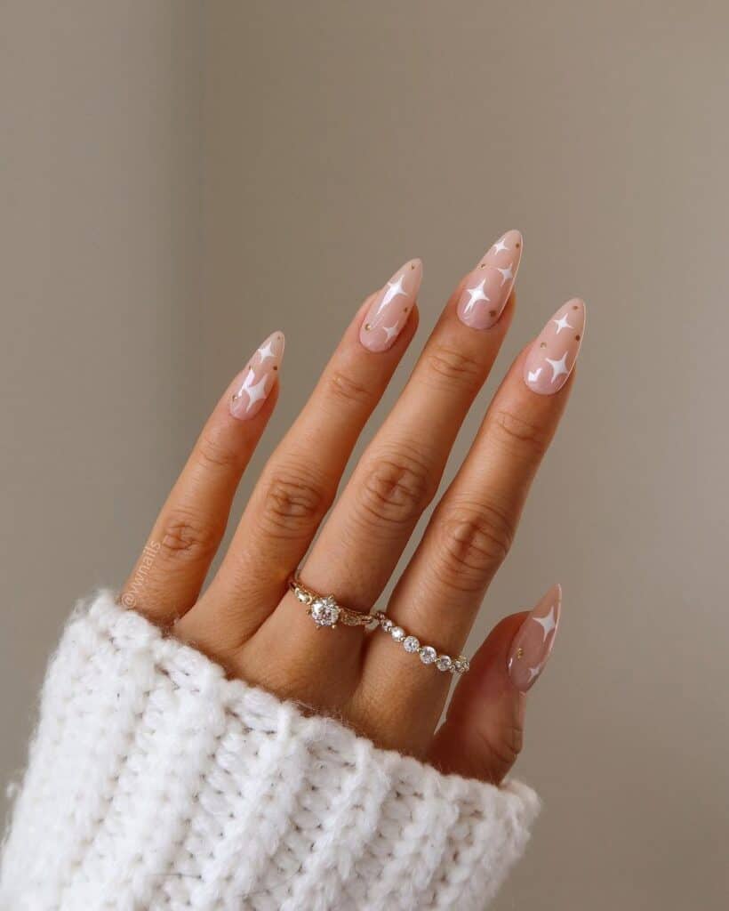White Star Motifs on Sheer Nude Stiletto Nails White Star Motifs on Sheer Nude Stiletto Nails — NYE Nails 2027