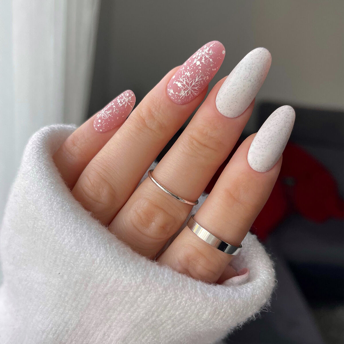Light Pink Almond Nails with Scattered Snowflakes Light Pink Almond Nails with Scattered Snowflakes — Snowflake Nails